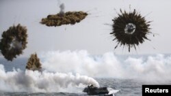 People throw colored powder during the Holi festival in Santa Coloma de Gramenet, near Barcelona, Spain.