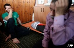 Relatives of 18-month-old Palestinian toddler Ali Saad Dawabsha, who died after his house was set on fire by Jewish settlers, mourn next to his body lying at a mosque during his funeral in the West Bank village of Duma, July 31, 2015.