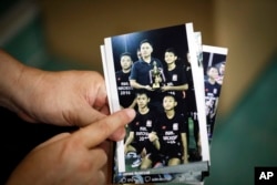 Banphot Konkum, father of Duangpetch Promthep, one of the rescued Thai boys, shows a picture of his son during an interview at their home in Mae Sai district, Chiang Rai province, northern Thailand, July 13, 2018.