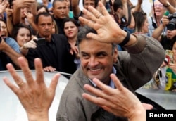 FILE - Brazil's presidential candidate Aecio Neves of Brazilian Social Democratic Party (PSDB) greets supporters in Sao Joao del Rei, Oct. 25, 2014.