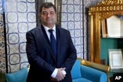 Rene Trabelsi poses for photographers before being introduced as proposed new tourism minister during a confidence vote at the National Assembly in Tunis, Tunisia, Nov. 12, 2018.