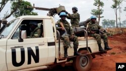 FILE - In this photo taken May 26, 2017, U.N. peacekeepers patrol outside Bria, Central African Republic. The United Nations said at the time that about 300 people had been killed and 200 wounded in the previous two weeks in Bria and a handful of other towns.
