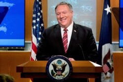 FILE - U.S. Secretary of State Mike Pompeo smiles during a news conference at the State Department, in Washington, April 29, 2020.