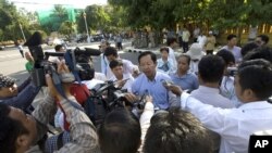 Rong Chhun, rear center, Cambodian Teacher Independence Association's president gives a press conference on a street as he walking to the protesting site, file photo. 