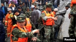 Des secouristes recherchent des personnes portées disparues après un glissement de terrain dans le village Xinmo, Chine, 24 juin 2017.