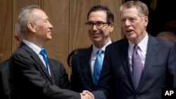 Treasury Secretary Steve Mnuchin, center, and United States Trade Representative Robert Lighthizer, right, speak with Chinese Vice Premier Liu He, left, as he leaves the Office of the United States Trade Representative in Washington, Friday, May 10, 2019. 