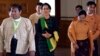 Pro-democracy leader Aung San Suu Kyi, center, walks along with lawmakers of her National League for Democracy (NLD) party to attend the inauguration session of Union Parliament, Feb. 8, 2016, in Naypyitaw, Myanmar. 