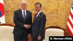 U.S. Vice President Mike Pence greets South Korean President Moon Jae-in in the Blue House, the executive office and official residence, Feb. 8, 2018 in Seoul, South Korea.