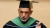Afghan President Hamid Karzai, wearing an academy gown, delivers a speech as he receives an honorary doctorate at Nippon Sport Science University in Tokyo, July 9, 2012. 