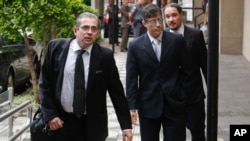 State prosecutors Jose Carlos Blat, left, Cassio Roberto Conserino, center, and Fernando Henrique de Moraes Araujo, responsible for the charges against Brazil's former President Luiz Inacio Lula da Silva, arrive for a press conference at the Attorneys Gen