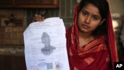 In this April 14, 2019 photo, Mahek Liaqat, who married a Chinese national, shows her marriage certificate in Gujranwala, Pakistan. Poor Pakistani Christian girls are being lured into marriages with Chinese men, whom they are told are Christian and wealth