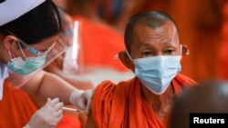 A Buddhist monk receives a dose of the AstraZeneca COVID-19 vaccine at a temple as the in Bangkok on July 30, 2021. Chalinee Thirasupa/Reuters 