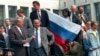 FILE - In this Aug. 19, 1991, photo, Boris Yeltsin, foreground left, at the time president of the Russian constituent republic within the Soviet Union, addresses a crowd standing atop of a tank in front of the "Russian White House," in Moscow, Russia.