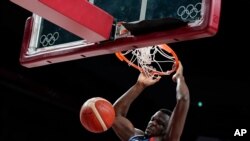 France's Moustapha Fall dunks during men's basketball preliminary round game against Iran at the 2020 Summer Olympics, July 31, 2021, in Saitama, Japan. 