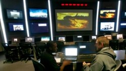 FILE - Recruiter Sgt. Mario Ashe, left, and Christopher Stevens talk in the tactical operations center area of the U.S. Army Experience center at the Franklin Mills mall in Philadelphia, Jan. 7, 2009.