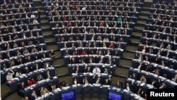 FILE - Lawmakers are seen during a voting session at the European Parliament in Strasbourg, France, Dec. 17, 2014.