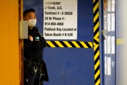 FILE - An Asian American New York City Police officer patrols in the Queens borough of New York, March 30, 2021. Police have stepped up patrols across the city in the wake of increased anti-Asian hate crimes.
