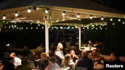 People have drinks before pubs close ahead of a lockdown in Vauxhall, London, Nov. 4, 2020.