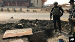 A soldier with Iraq's elite counterterrorism force inspects a tunnel made by Islamic State militants in Bartella, Iraq, Oct. 27, 2016. The town of Bartella in northern Iraq is about 20 kilometers east of Mosul.