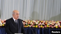 FILE - Algerian President Abdelmadjid Tebboune takes the oath during a swearing-in ceremony in Algiers, Algeria, Dec. 19, 2019. 