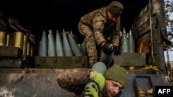 Ukrainian artillerymen unload shells from a military truck at a position on the front line near the town of Bakhmut, in eastern Ukraine's Donetsk region, on October 31, 2022, amid the Russian invasion of Ukraine.