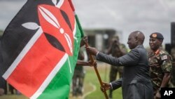 Kenya's President William Ruto, left, attends a flag-handover ceremony for members from the Kenya Defence Forces (KDF), ahead of their deployment to eastern Democratic Republic of Congo at the Embakasi garrison in Nairobi, Kenya, Nov. 2, 2022. 