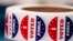 FILE — "I VOTED EARLY' stickers sit at a Milwaukee polling station, Oct. 25, 2022. Most states have found common ground in allowing early in-person voting. Today, 46 states and the District of Columbia allow early voting.