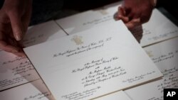 FILE - Invitations for Prince Harry and Meghan Markle's wedding in May, after they have been printed at the workshop of Barnard and Westwood in London, March 22, 2018.
