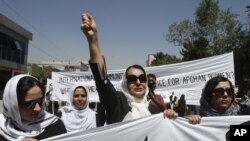 An Afghan protestor shouts slogans during a demonstration in support of female victims of abuse and violence in Kabul, Afghanistan, July 11, 2012.
