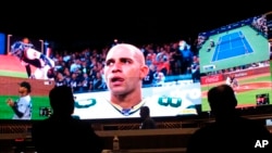 People watch video screens in the sports betting lounge at Bally's casino in Atlantic City N.J., Sept. 5, 2019. (AP Photo/Wayne Parry, FIle)