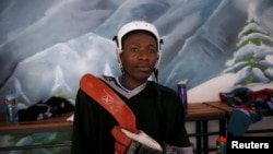 FILE - A member of Kenya's ice hockey team watches his teammates from the bench during a practice session in East Africa's only ice rink, in Nairobi, Jan. 20, 2018. The team had no practice space after the rink shut down in 2020 because of the pandemic.
