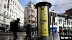 FILE - A guidance sign is pictured following the outbreak of the coronavirus disease (COVID-19) in Manchester, Britain, Oct. 7, 2020. 