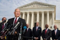 FILE - Nebraska Attorney General Doug Peterson with a bipartisan group of state attorneys general speaks to reporters in front of the U.S. Supreme Court in Washington, Sept. 9, 2019.