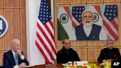 President Joe Biden meets virtually with Indian Prime Minister Narendra Modi in Washington, April 11, 2022. India's Defense minister Rajnath Singh, is center, and India's foreign minister Subrahmanyam Jaishankar, is right .