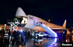 An Iranian plane carries aid at a Damascus airport in Syria, in this undated handout released by SANA on Feb. 7, 2023.