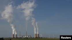 FILE - Smoke billows from the cooling towers of Kriel and Matla Power Stations, coal-fired stations of South African utility Eskom, Jan. 17, 2023.