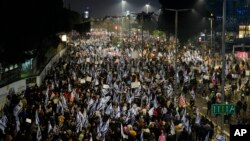 Israelis protest against plans by Prime Minister Benjamin Netanyahu's new government to overhaul the judicial system, in Tel Aviv, Israel, Jan. 28, 2023. 