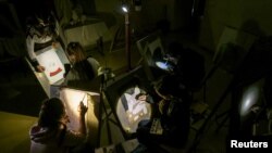 Sejumlah siswa mengikuti pelajaran di sekolah seni saat listrik padam, setelah infrastruktur sipil yang kritis dihantam oleh serangan rudal dan pesawat tak berawak Rusia di Kyiv, Ukraina, 23 Desember 2022. (Foto: Reuters)