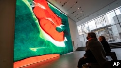 Visitors view artist Refik Anadol's "Unsupervised" exhibit at the Museum of Modern Art, Jan. 11, 2023, in New York.