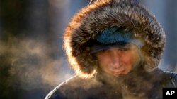 A passenger disembarks from a ferry arriving from Peaks Island, Feb. 4, 2023, in Portland, Maine. The morning temperature was about -10 degrees Fahrenheit. 