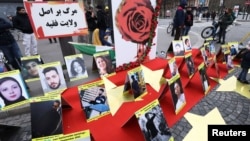 Pictures of people who died during anti-government demonstrations in Iran are displayed as Iranian community members and their supporters take part in a protest in solidarity with the Iranian people, in Paris, France, Feb. 12, 2023.