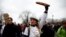 A baker holds a loaf of bread during a demonstration of French bakers and artisans to demand governmental aid in the face of soaring energy prices, in Paris, France, Jan. 23, 2023. 