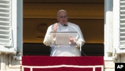 FILE - Pope Francis delivers his speech during the Angelus noon prayer from the window of his studio overlooking St. Peter's Square, at the Vatican, Feb. 12, 2023.
