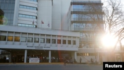 FILE - Protesters stand outside the Ministry of Health as part of a demonstration against the Coastal GasLink pipeline, in Victoria, British Columbia, Feb. 14, 2020.