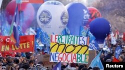 Protesters rally against the French government's pension reform plan, in Paris, Feb. 7, 2023.