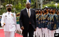 U.S. Defense Secretary Lloyd Austin walks past military guards during his arrival at the Department of National Defense in Camp Aguinaldo military camp in Quezon City, Metro Manila, Philippines, Feb. 2, 2023. Rolex Dela Pena/Pool Photo via AP)