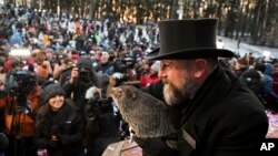 A.J. Dereume holds Punxsutawney Phil during the 137th celebration of Groundhog Day in Punxsutawney, Pa., Feb. 2, 2023. (AP Photo/Barry Reeger)