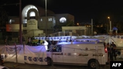 Israeli emergency service personnel close off the site of an attack at a synagogue in a settler neighborhood of Israeli-annexed East Jerusalem, on Jan. 27, 2023.
