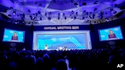 First Lady of Ukraine Olena Zelenska is seen on video screens as she delivers a speech at the World Economic Forum in Davos, Switzerland, Jan. 17, 2023. 