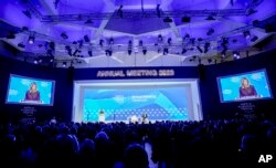 First Lady of Ukraine Olena Zelenska is seen on video screens as she delivers a speech at the World Economic Forum in Davos, Switzerland, Jan. 17, 2023.